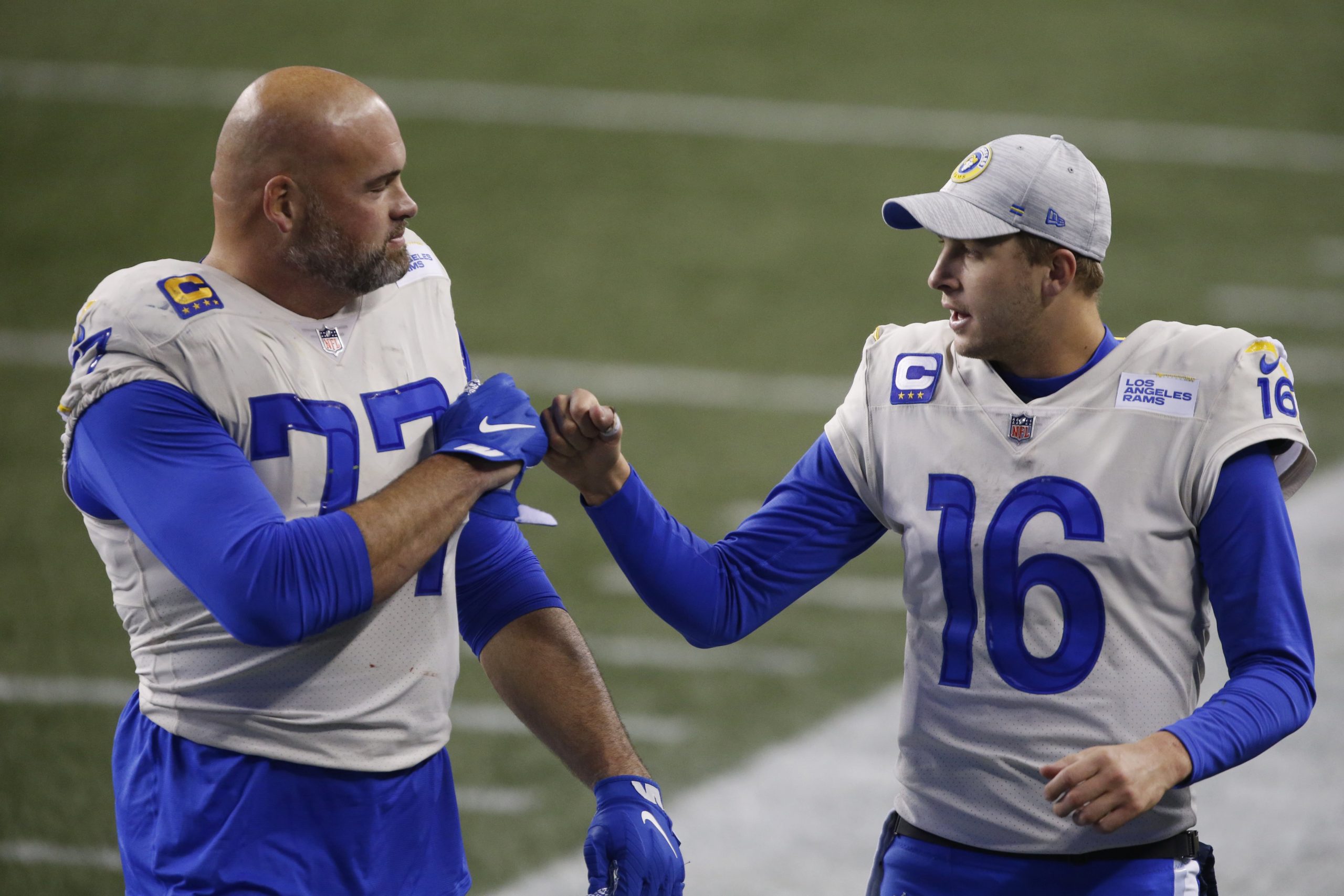 Los Angeles Rams quarterback Jared Goff (16) and offensive tackle Andrew Whitworth (77) celebrate after the game against the Seattle Seahawks at Lumen Field.