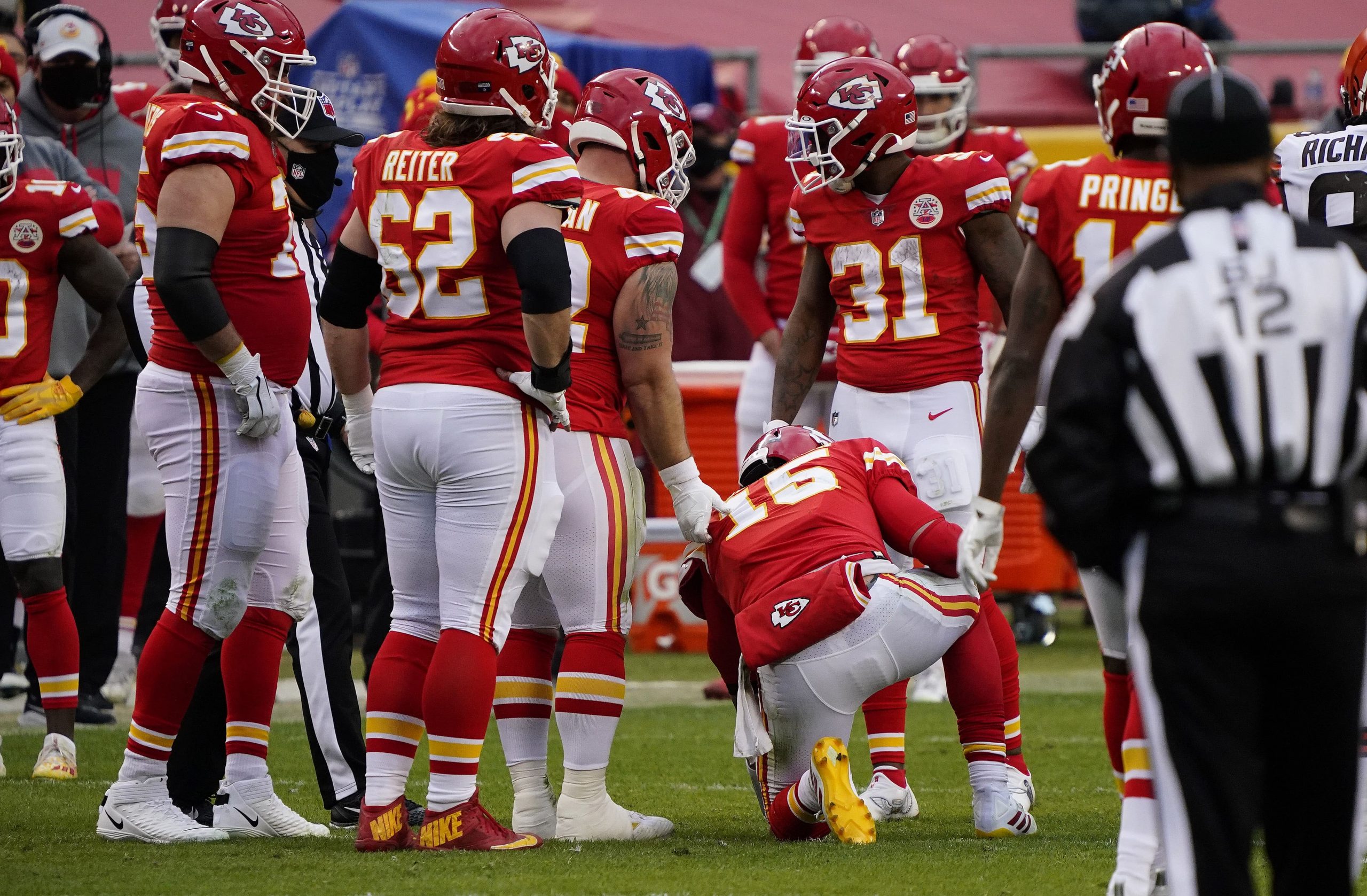 Kansas City Chiefs teammates surround a shaken up Patrick Mahomes during playoff win over Cleveland Browns