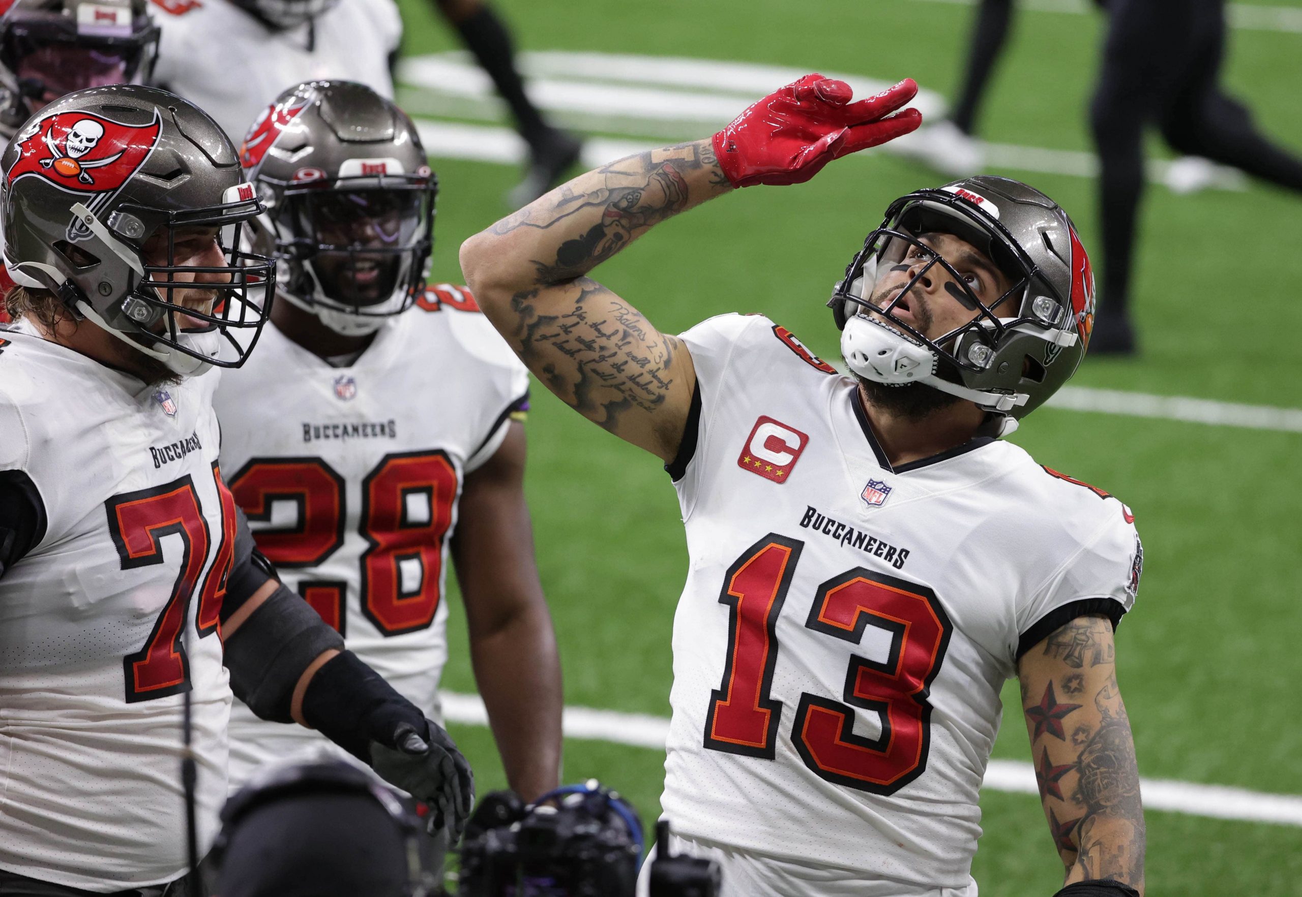 Tampa Bay Buccaneers wide receiver Mike Evans (13) celebrates after a touchdown catch against the New Orleans Saints during the second quarter in a NFC Divisional Round playoff game at Mercedes-Benz Superdome.