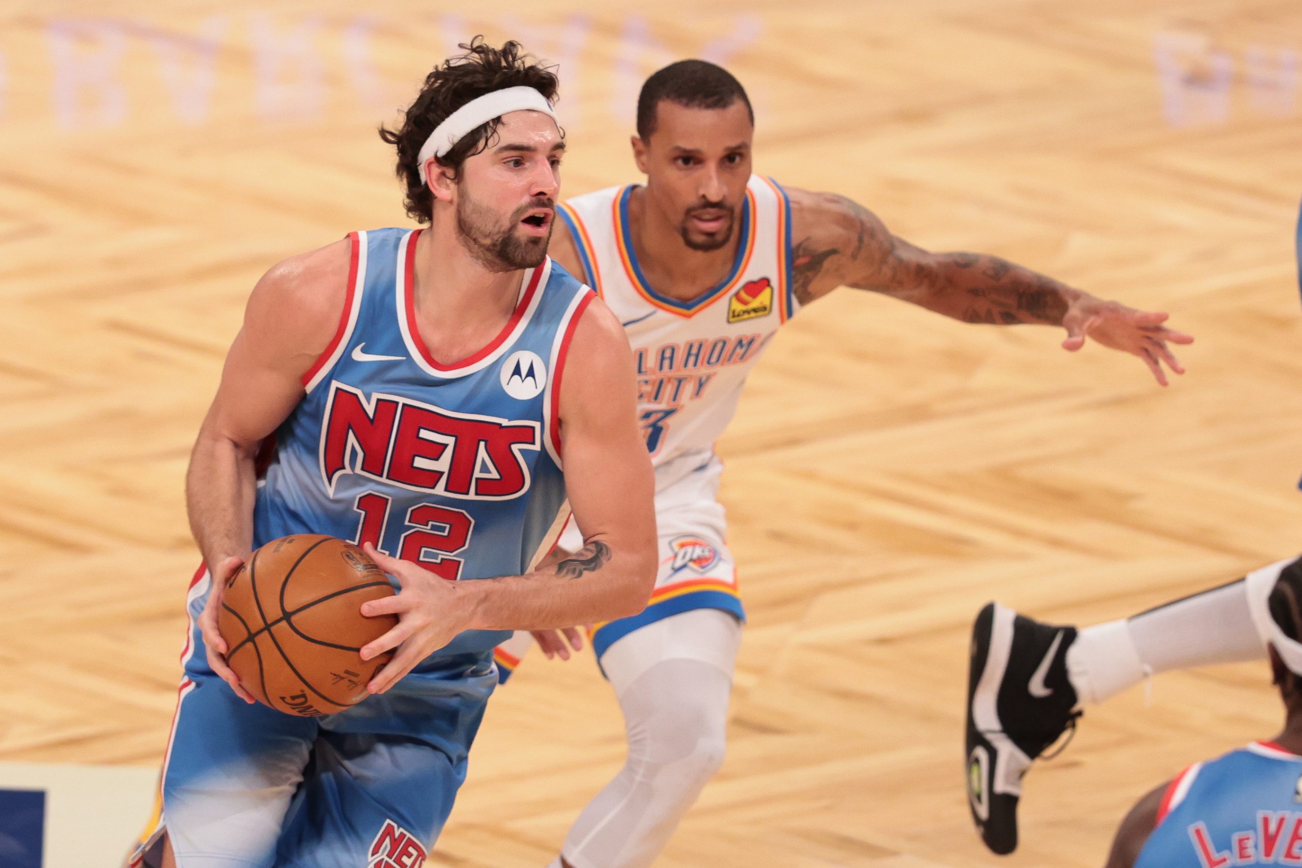 Jan 10, 2021; Brooklyn, New York, USA; Brooklyn Nets guard Joe Harris (12) looks to pass as Oklahoma City Thunder guard George Hill (3) defends during the second half at Barclays Center.