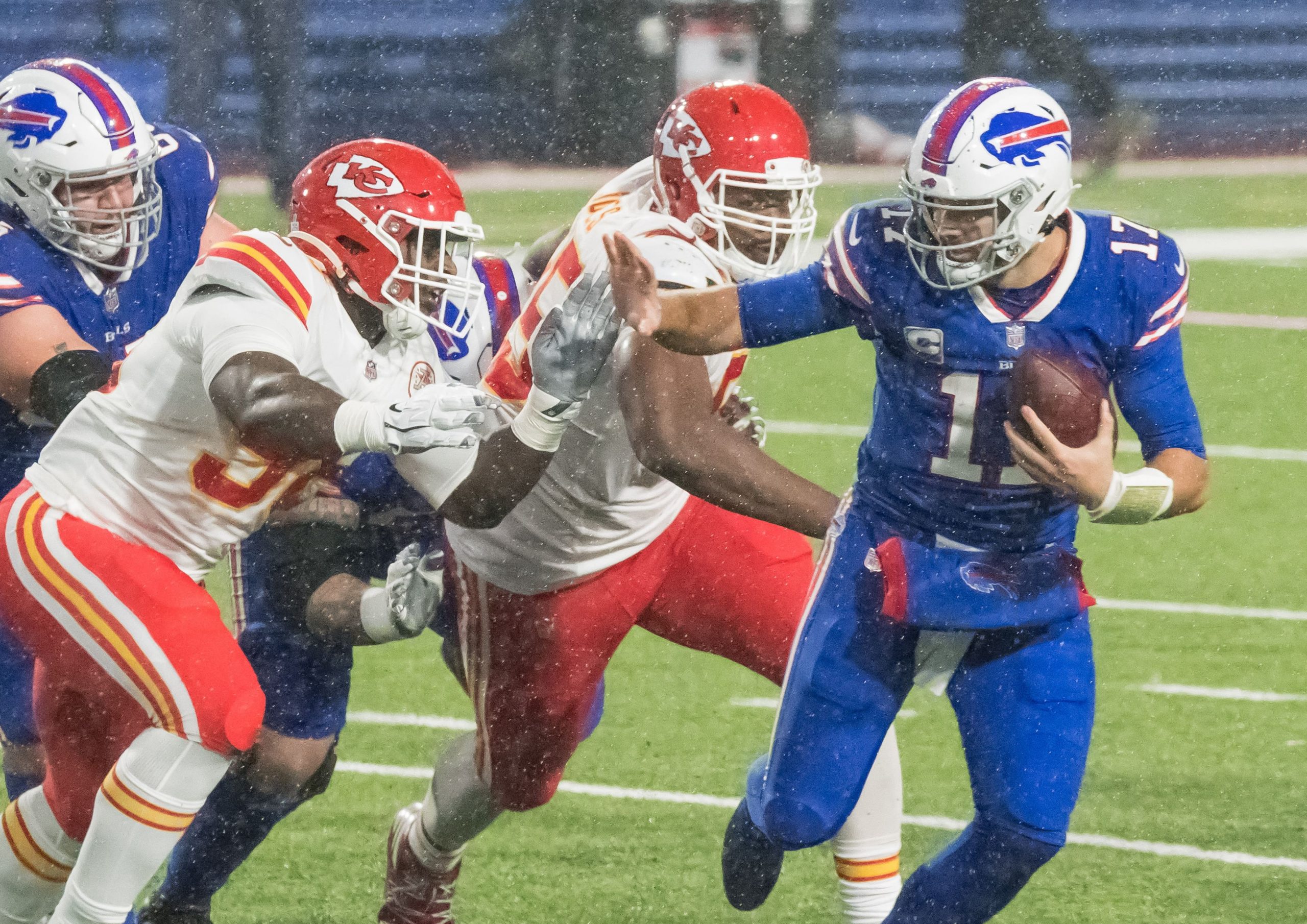 Buffalo Bills quarterback Josh Allen (17) runs against Kansas City Chiefs defensive tackle Tershawn Wharton (98) in the fourth quarter at Bills Stadium.