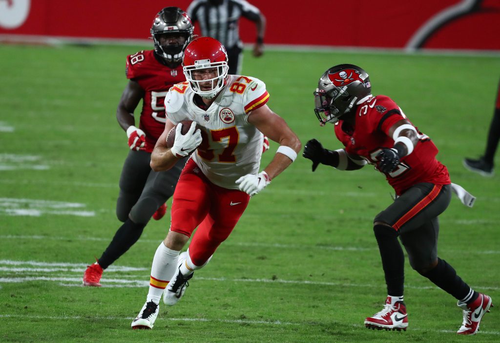 Kansas City Chiefs tight end Travis Kelce (87) runs the ball against Tampa Bay Buccaneers safety Mike Edwards (32) during the second half at Raymond James Stadium.