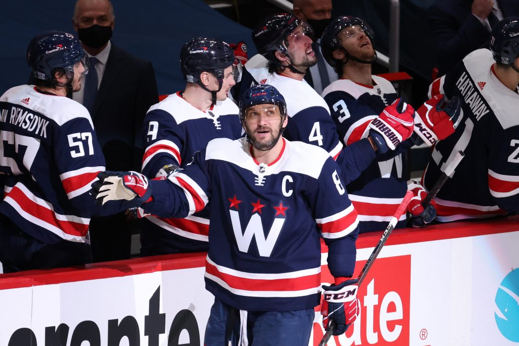 Washington Capitals left wing Alex Ovechkin (8) celebrates with teammates after scoring a goal against the Philadelphia Flyers in the second period at Capital One Arena.