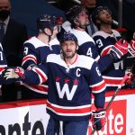 Washington Capitals left wing Alex Ovechkin (8) celebrates with teammates after scoring a goal against the Philadelphia Flyers in the second period at Capital One Arena.