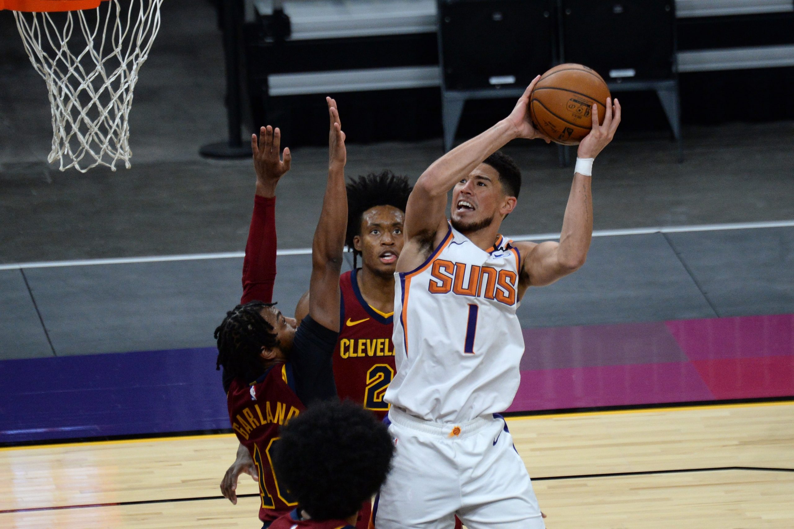 Phoenix Suns guard Devin Booker (1) shoots over Cleveland Cavaliers guard Darius Garland (10) during the second half at Phoenix Suns Arena.