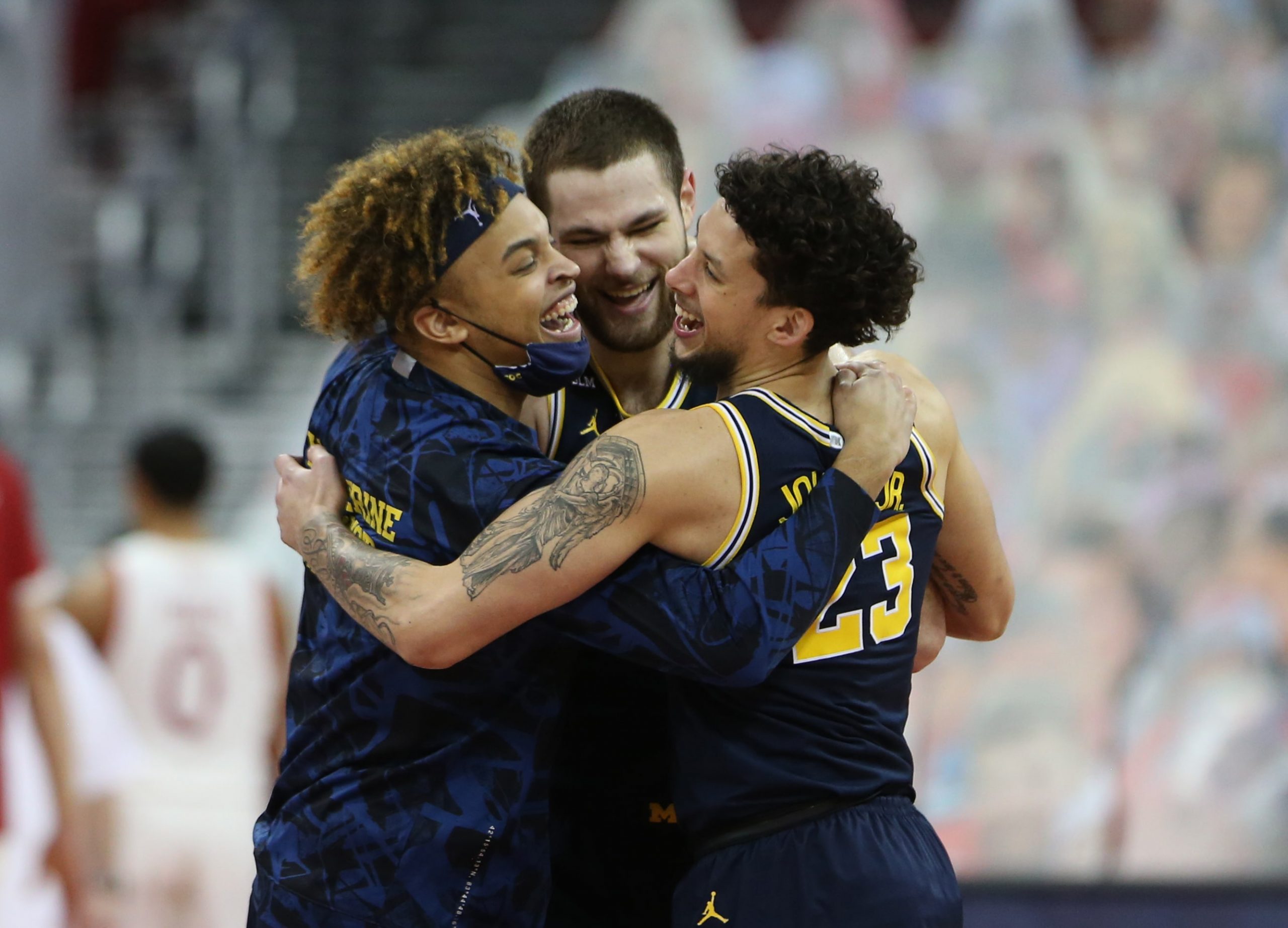 Michigan Wolverines players including Michigan Wolverines center Hunter Dickinson (center) and forward Brandon Johns Jr. (23) celebrate their win over the Wisconsin Badgers after the game at the Kohl Center