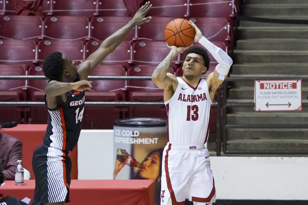 Alabama Crimson Tide guard Jahvon Quinerly (13) shoots against Georgia Bulldogs guard Tye Fagan (14) during the second half at Coleman Coliseum