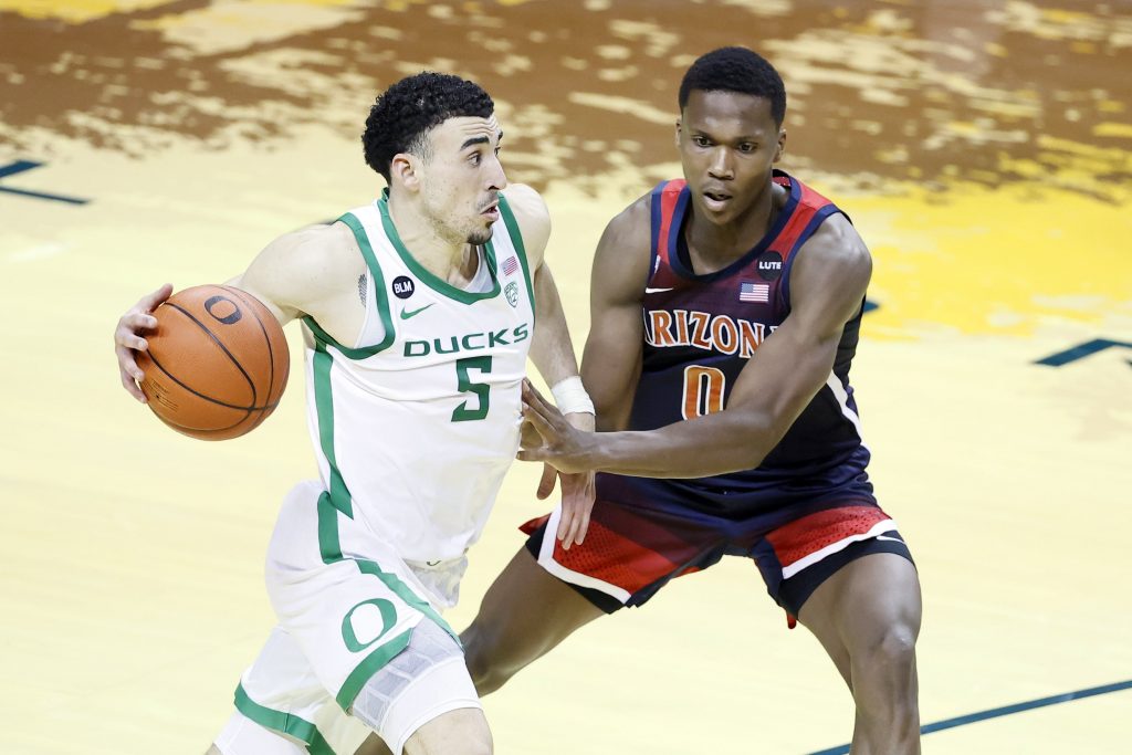 Mar 1, 2021; Eugene, Oregon, USA; Oregon Ducks guard Chris Duarte (5) dribbles the ball as Arizona Wildcats guard Bennedict Mathurin (0) defends during the second half at Matthew Knight Arena.