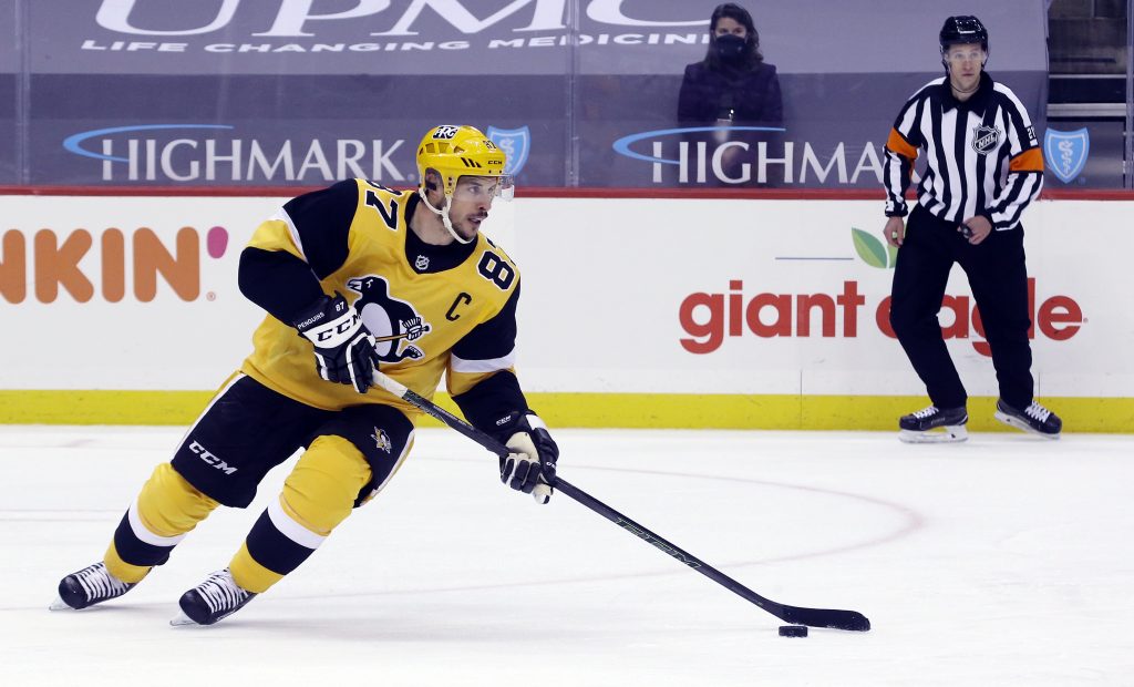 Mar 9, 2021; Pittsburgh, Pennsylvania, USA; Pittsburgh Penguins center Sidney Crosby (87) skates with the puck against the New York Rangers during the third period at PPG Paints Arena.