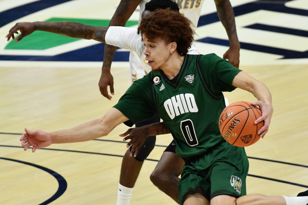 Ohio Bobcats guard Jason Preston (0) drives to the basket against Toledo Rockets guard Keshaun Saunders (24) during the first half at Rocket Mortgage FieldHouse