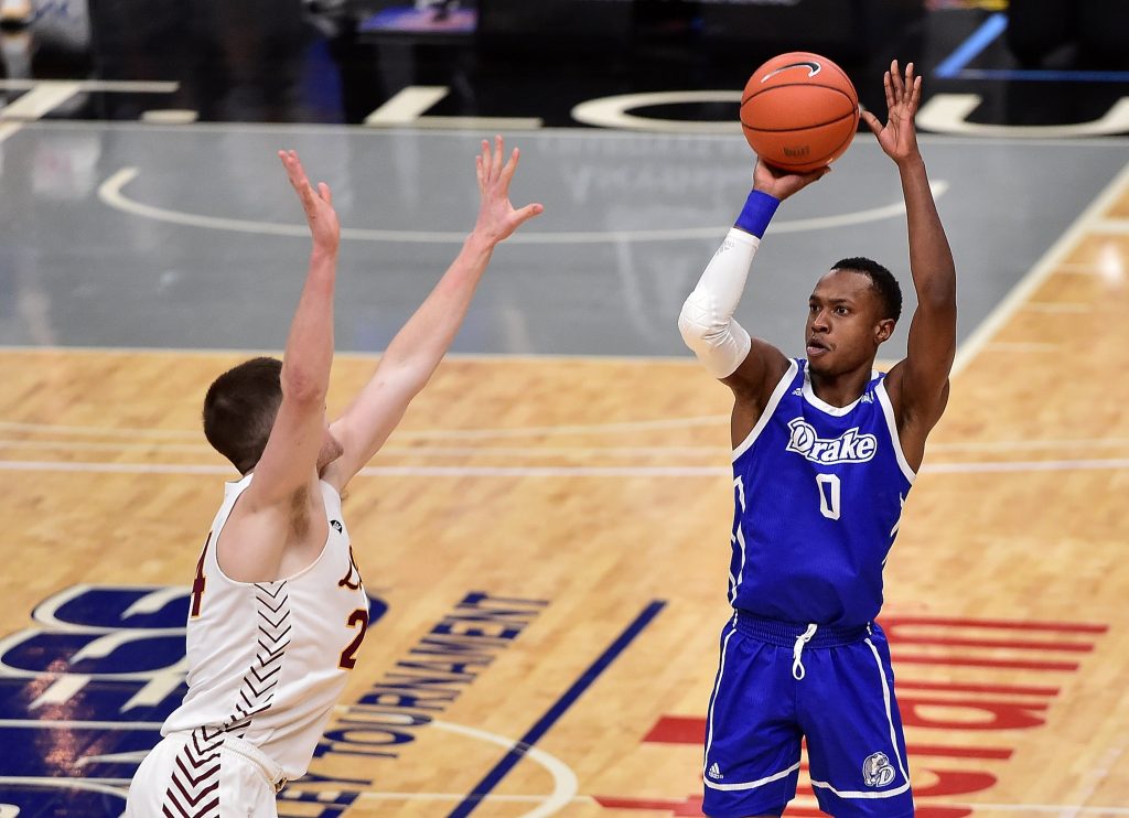 Drake Bulldogs guard D.J. Wilkins (0) shoots as Loyola Ramblers guard Tate Hall (24) defends during the first half in the finals of the Missouri Valley Conference Tournament at Enterprise Center