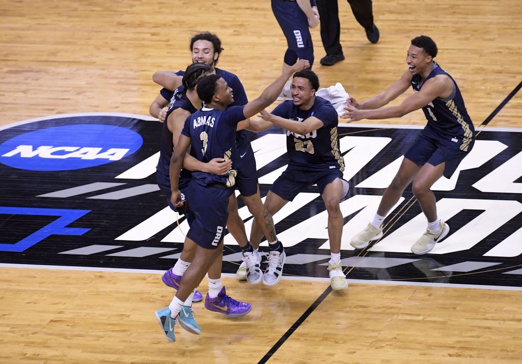 Oral Roberts Golden Eagles celebrate their 81-78 victory over the Florida Gators during the second round of the 2021 NCAA Tournament on Sunday, March 21, 2021, at Indiana Farmers Coliseum in Indianapolis.