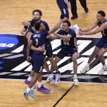 Oral Roberts Golden Eagles celebrate their 81-78 victory over the Florida Gators during the second round of the 2021 NCAA Tournament on Sunday, March 21, 2021, at Indiana Farmers Coliseum in Indianapolis.