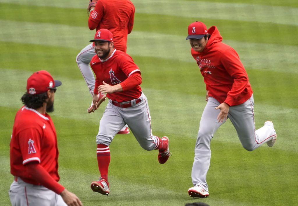 Los Angeles Angels designated hitter Shohei Ohtani (17) jokes around with third baseman David Fletcher (22) before a spring training game against the Colorado Rockies at Salt River Fields at Talking Stick.