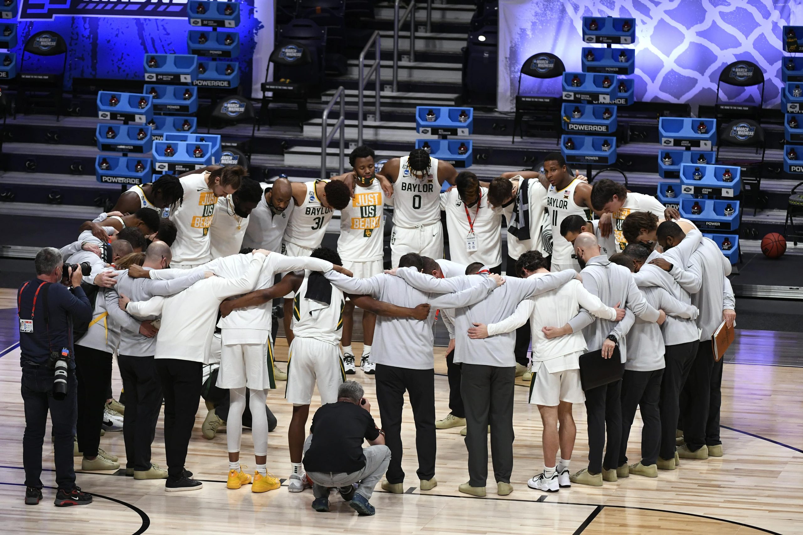 Baylor Bears players and staff huddle after defeating the Villanova Wildcats during the Sweet 16 of the 2021 NCAA Tournament at Hinkle Fieldhouse