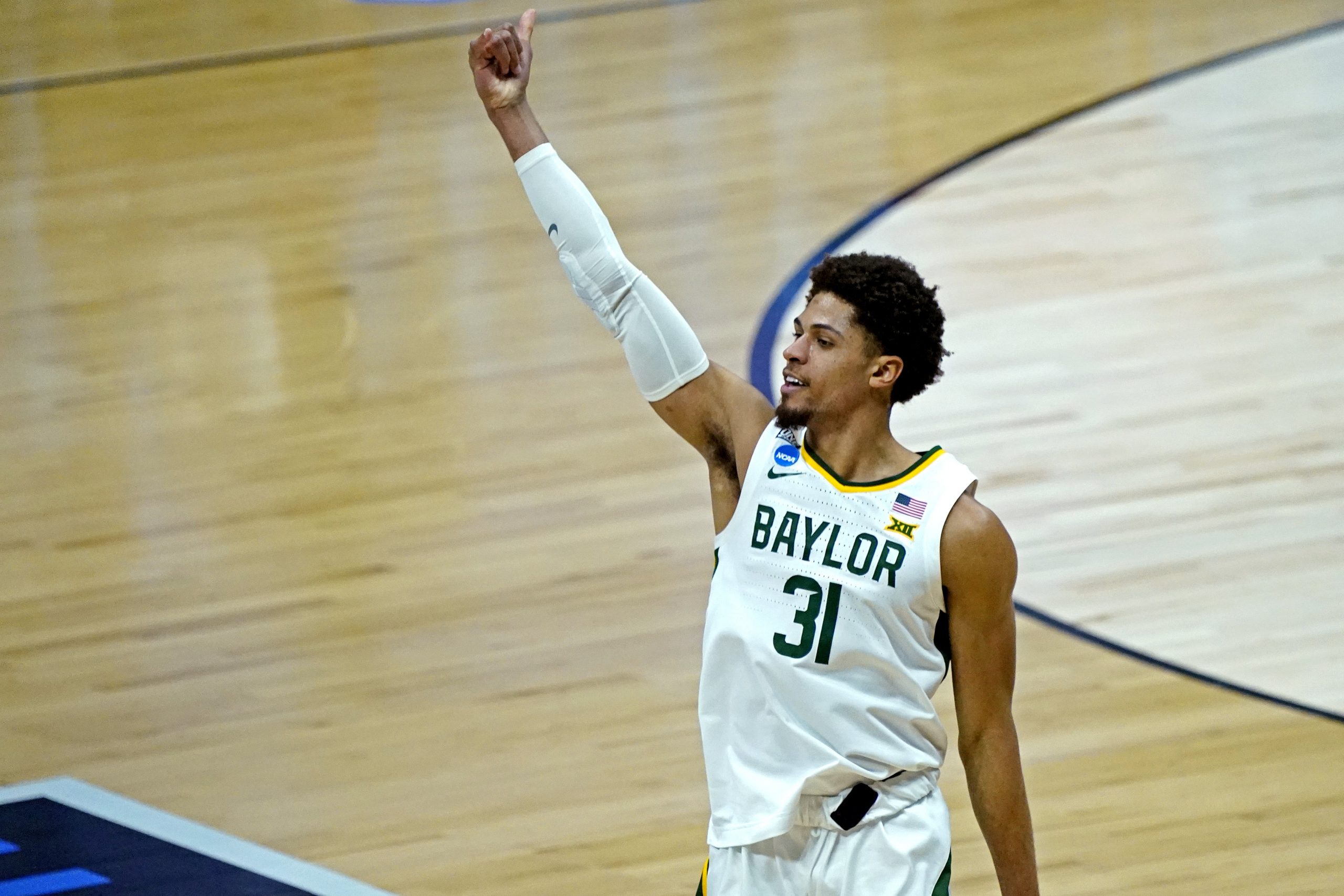 Baylor Bears guard MaCio Teague (31) celebrates after making a three point basket during the second half against the Arkansas Razorbacks in the Elite Eight of the 2021 NCAA Tournament at Lucas Oil Stadium