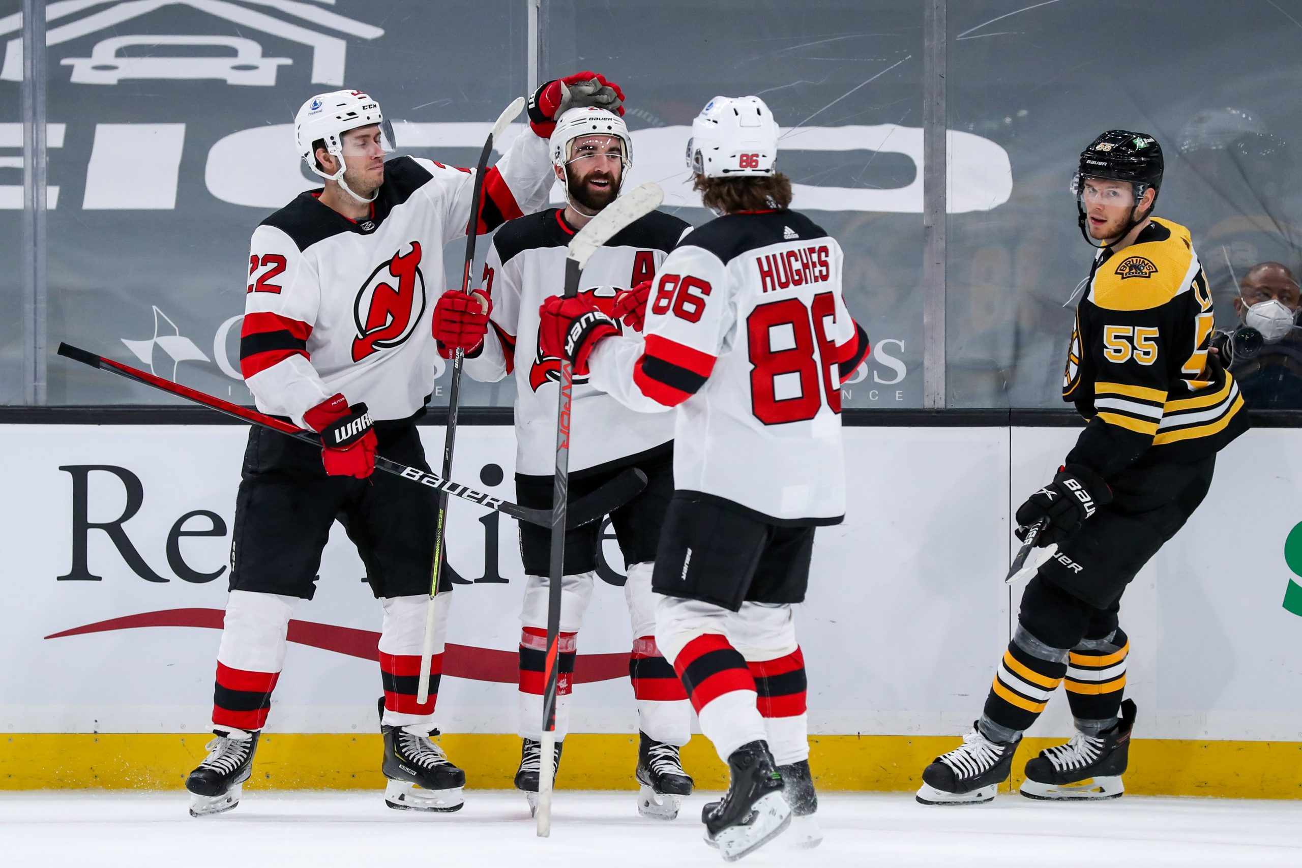 New Jersey Devils right wing Kyle Palmieri (21) celebrates with defenseman Ryan Murray (22) and center Jack Hughes (86) after scoring a goal