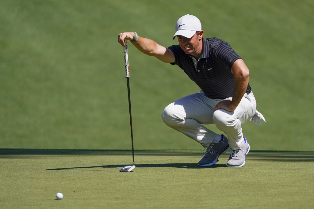 Rory McIlroy lines up a putt on the 10th green during a practice round for The Masters golf tournament at Augusta National Golf Club.