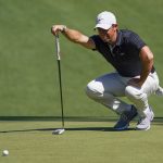Rory McIlroy lines up a putt on the 10th green during a practice round for The Masters golf tournament at Augusta National Golf Club.