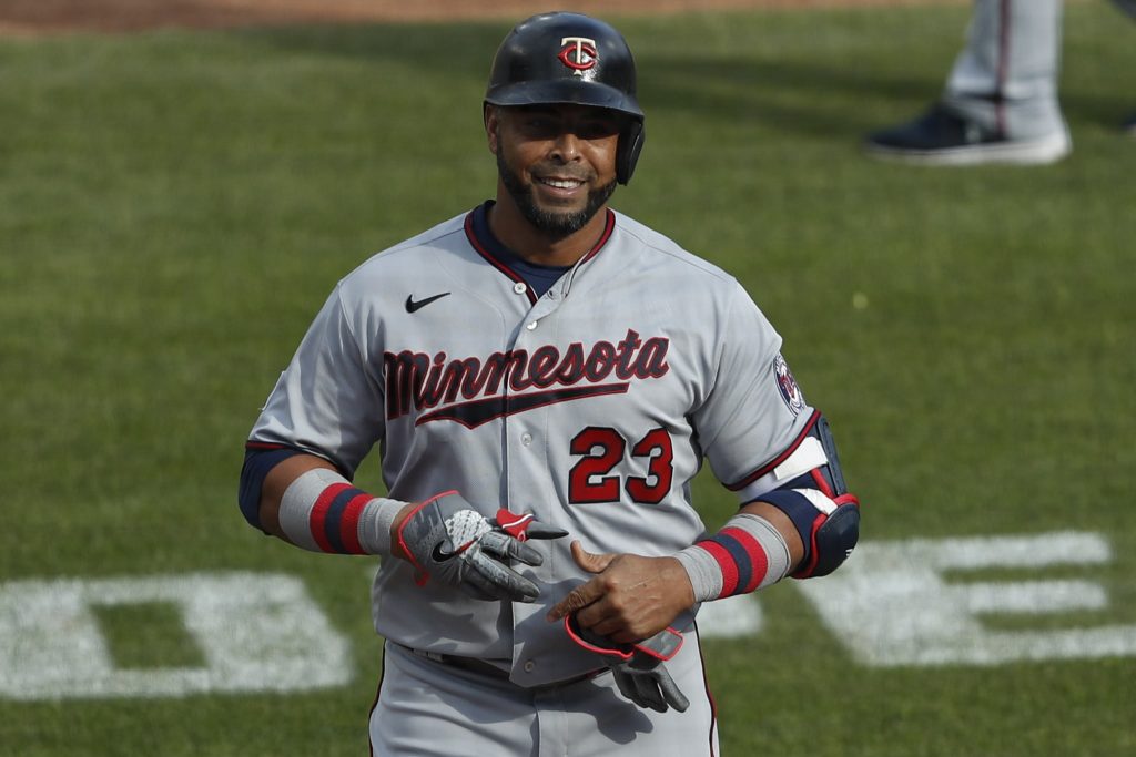 Minnesota Twins designated hitter Nelson Cruz (23) smiles as he walks off the field during the ninth inning against the Detroit Tigers at Comerica Park