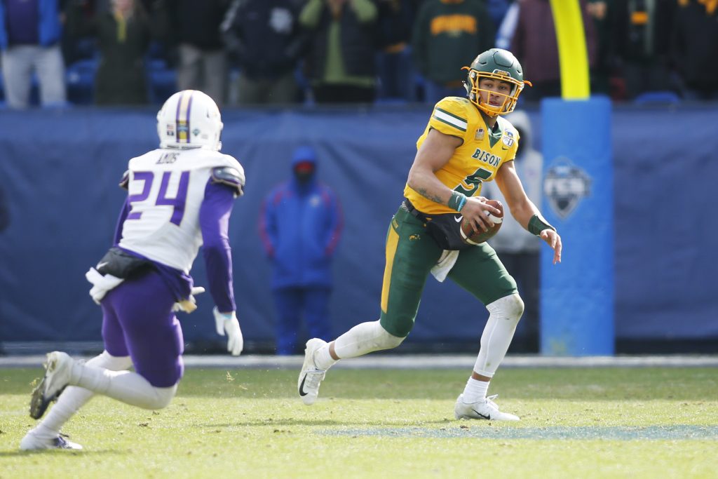 North Dakota State Bison quarterback Trey Lance (5) scrambles from James Madison Dukes safety D'Angelo Amos (24) in the third quarterat Toyota Stadium