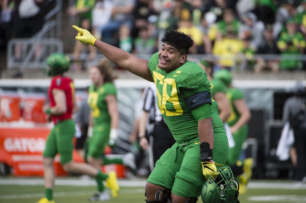 Oregon Ducks offensive lineman Penei Sewell (58) points the scoreboard after the Oregon spring game at Autzen Stadium