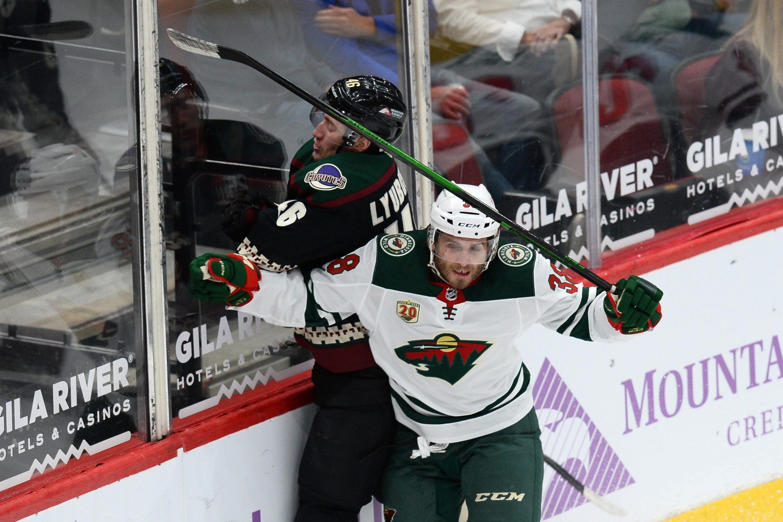 Minnesota Wild right wing Ryan Hartman checks Arizona Coyotes defenseman Ilya Lyubushkin