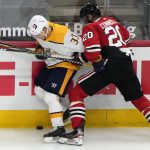 Chicago Blackhawks right wing Brett Connolly checks Nashville Predators right wing Viktor Arvidsson