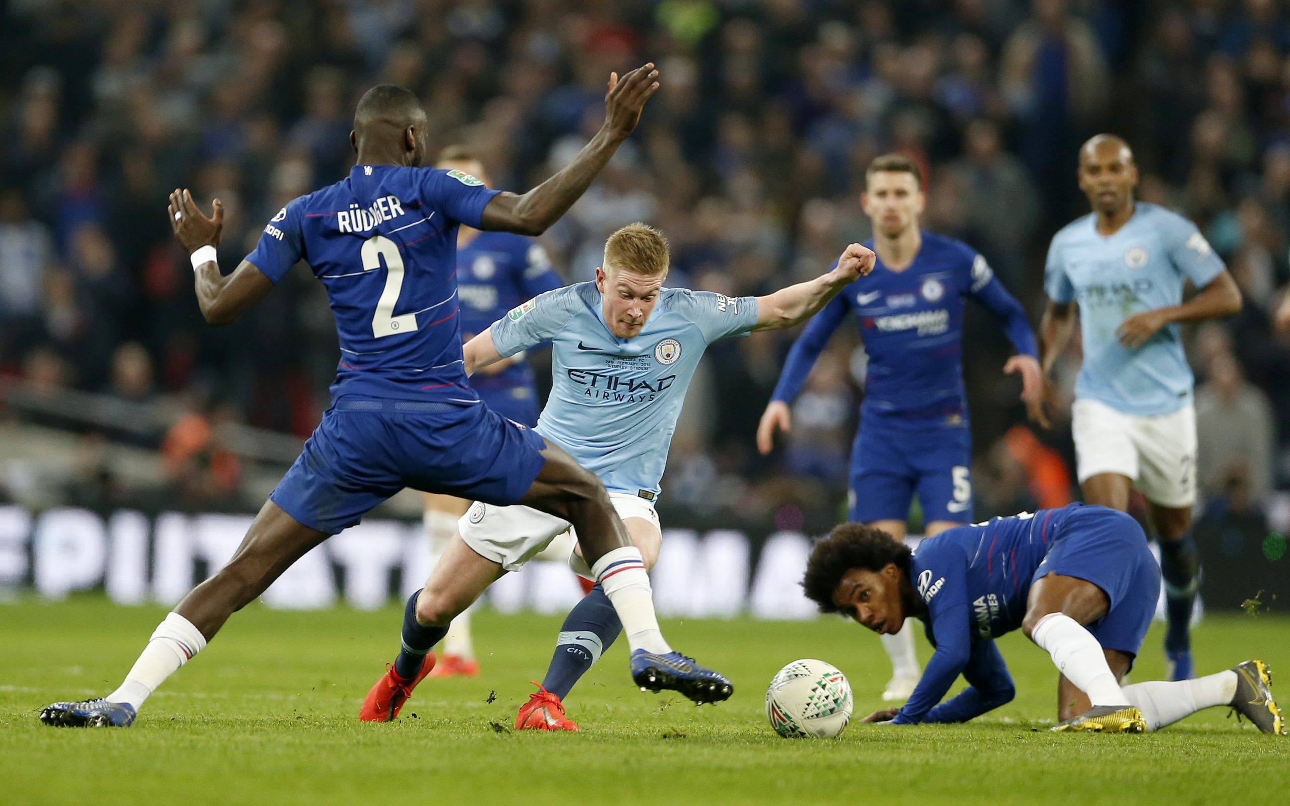 Manchester City’s Kevin De Bruyne (C) goes past Chelsea’s Antonio Rudiger (L) and Willian (R, on ground) during the Carabao Cup Final match between Chelsea and Manchester City at Wembley Stadium in London, Britain on Feb. 24, 2019.
