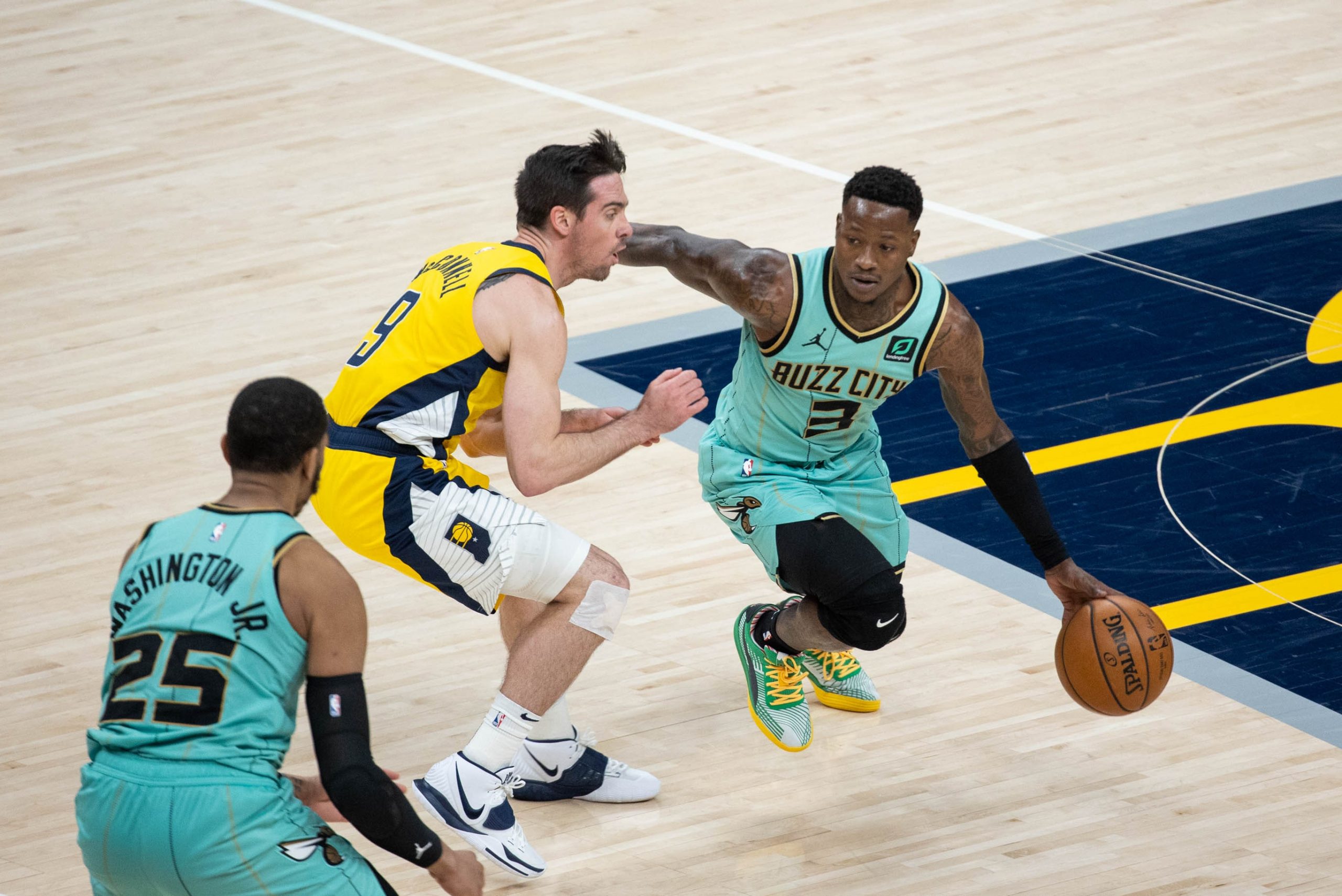 Charlotte Hornets guard Terry Rozier (3) dribbles the ball while Indiana Pacers guard T.J. McConnell (9) defends in the fourth quarter at Bankers Life Fieldhouse.