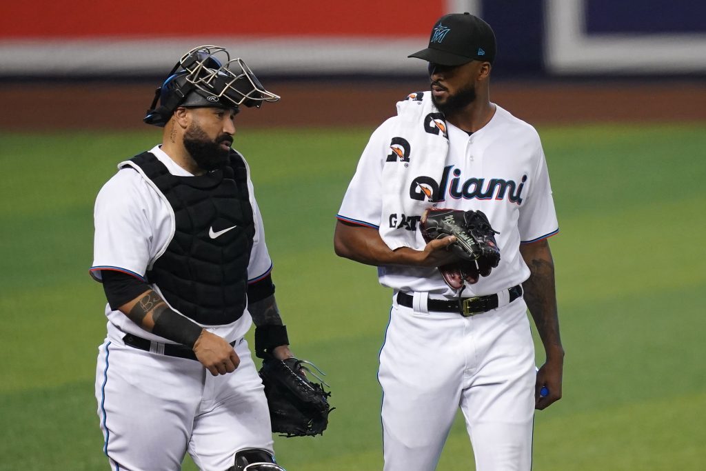 May 4, 2021; Miami, Florida, USA; Miami Marlins catcher Sandy Leon (L) and Miami Marlins starting pitcher Sandy Alcantara (R) walk to the dugout prior to the game against the Arizona Diamondbacks a at loanDepot park. Mandatory Credit: Jasen Vinlove-USA TODAY Sports