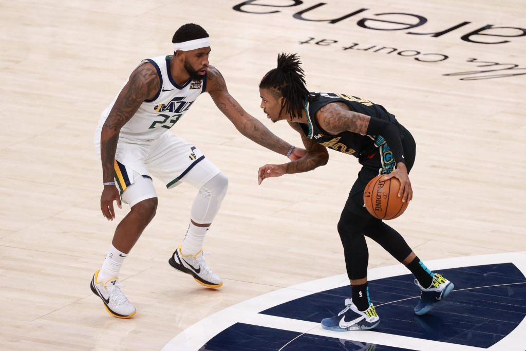 Memphis Grizzlies guard Ja Morant (12) controls the ball against Utah Jazz forward Royce O'Neale (23) during the fourth quarter at Vivint Arena. Memphis Grizzlies won 112-109.