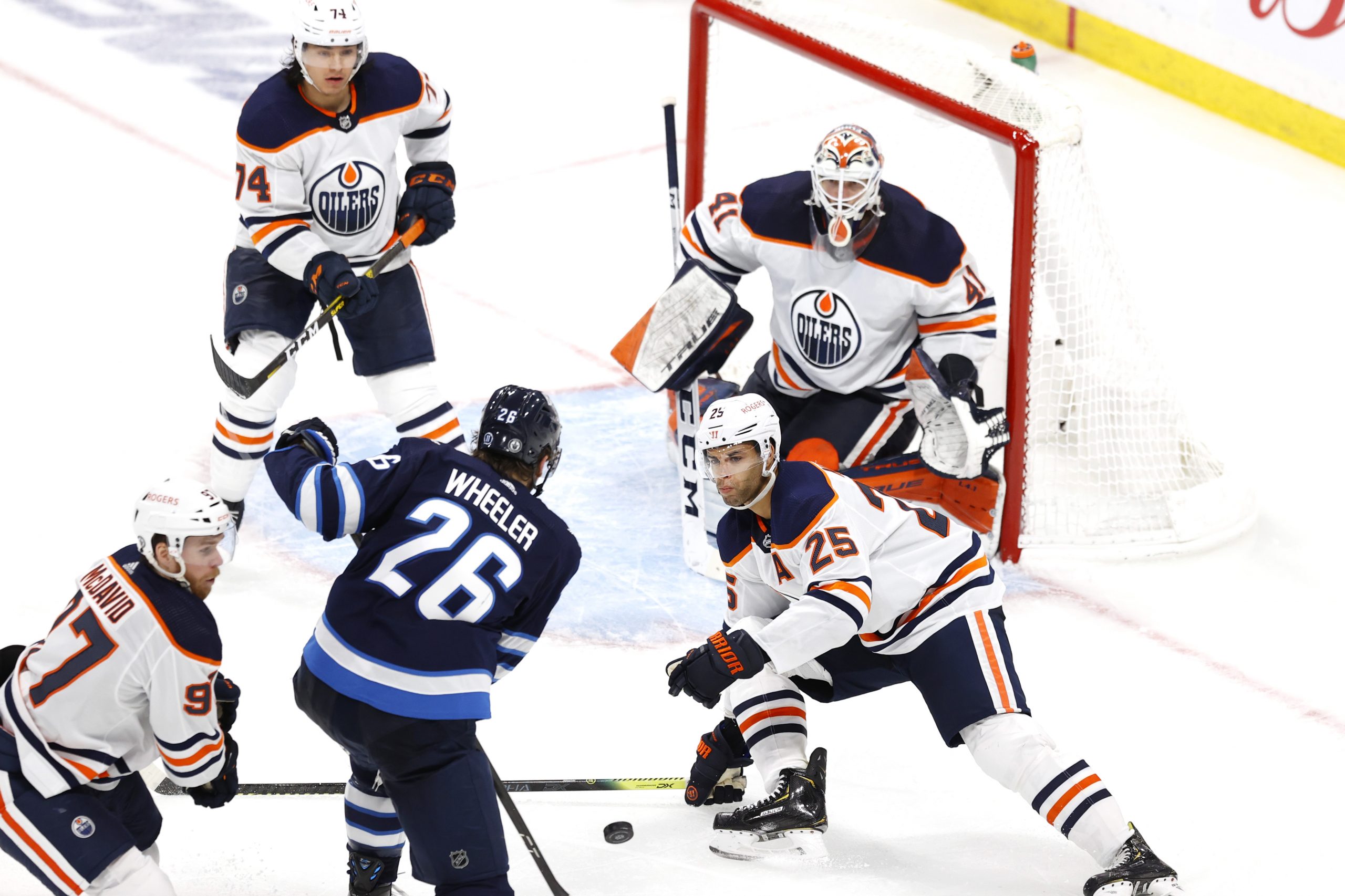 May 23, 2021; Winnipeg, Manitoba, CAN; Edmonton Oilers defenseman Darnell Nurse (25) blocks a shot by Winnipeg Jets right wing Blake Wheeler (26) in overtime in game three of the first round of the 2021 Stanley Cup Playoffs at Bell MTS Place.