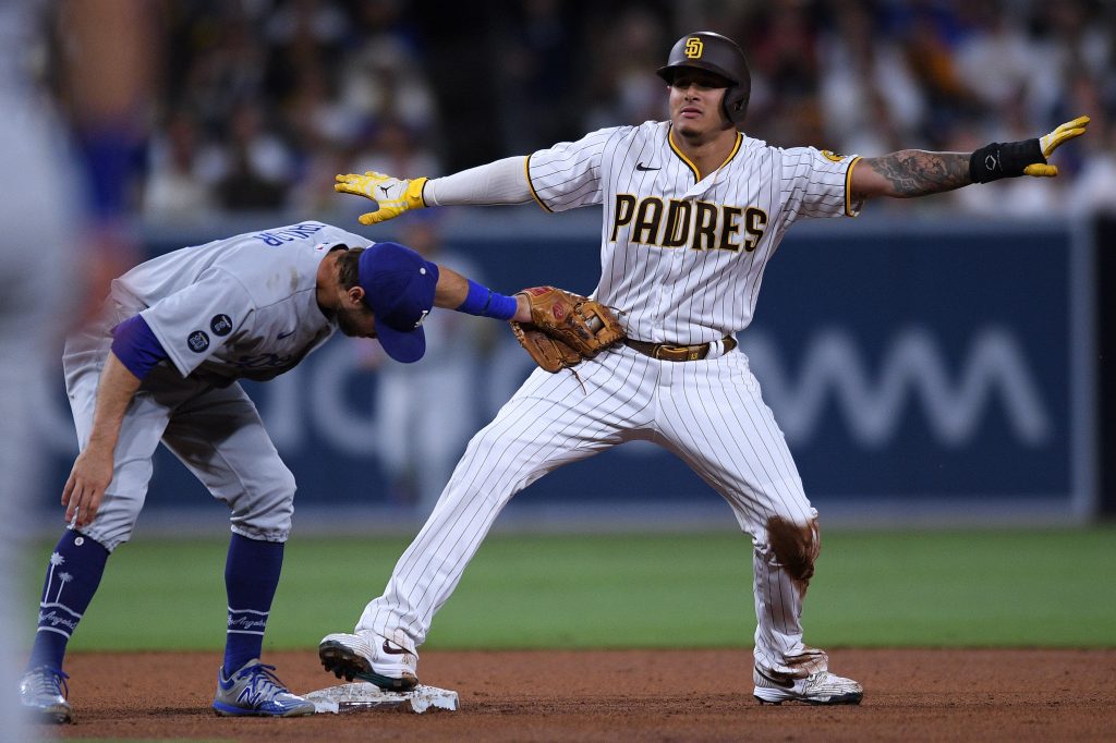 MLB: San Diego Padres third baseman Manny Machado (right) steals second base ahead of the tag by Los Angeles Dodgers second baseman Chris Taylor (left) during the fifth inning at Petco Park.