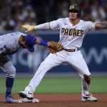 MLB: San Diego Padres third baseman Manny Machado (right) steals second base ahead of the tag by Los Angeles Dodgers second baseman Chris Taylor (left) during the fifth inning at Petco Park.