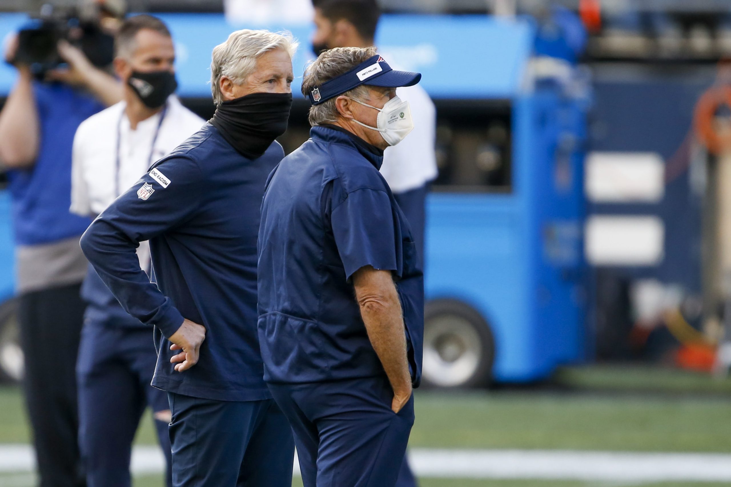 Seattle Seahawks head coach Pete Carroll, left, and New England Patriots head coach Bill Belichick watch pregame warmups at CenturyLink Field.