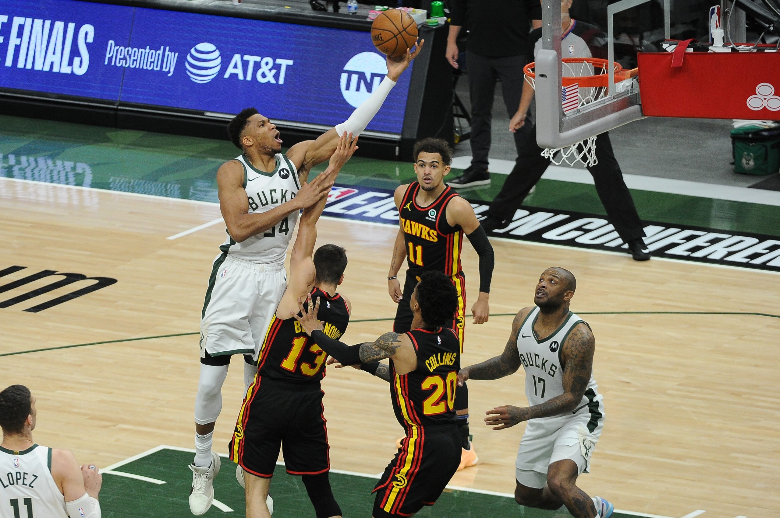 Milwaukee Bucks forward Giannis Antetokounmpo (34) shoots the ball over Atlanta Hawks guard Bogdan Bogdanovic (13) in the first quarter during game two of the Eastern Conference Finals for the 2021 NBA Playoffs at Fiserv Forum