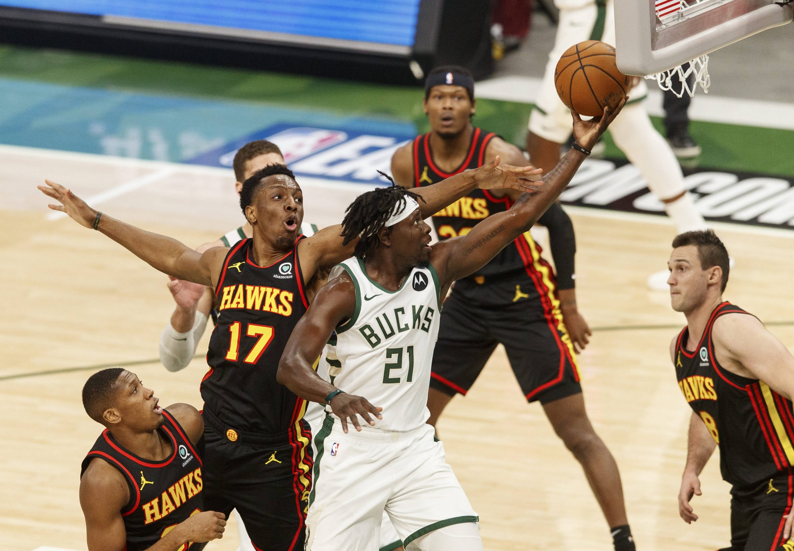 Milwaukee Bucks guard Jrue Holiday (21) shoots in front of Atlanta Hawks center Onyeka Okongwu (17) during the first quarter during game five of the Eastern Conference Finals for the 2021 NBA Playoffs at Fiserv Forum.