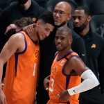 Phoenix Suns head coach Monty Williams hugs guard Devin Booker (1) as guard Chris Paul (3) looks on after the Suns beat the LA Clippers in game six of the Western Conference Finals for the 2021 NBA Playoffs at Staples Center pacific division pacific division
