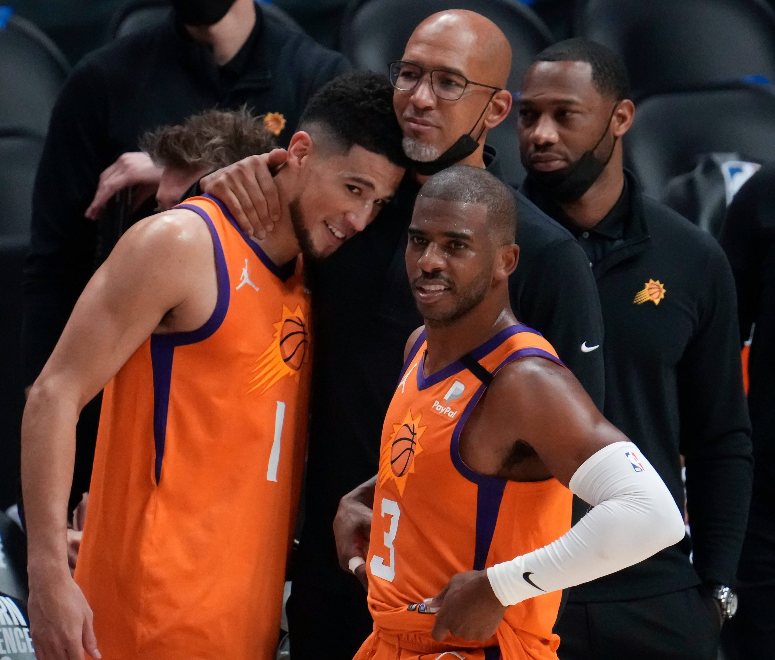 Phoenix Suns head coach Monty Williams hugs guard Devin Booker (1) as guard Chris Paul (3) looks on after the Suns beat the LA Clippers in game six of the Western Conference Finals for the 2021 NBA Playoffs at Staples Center pacific division pacific division