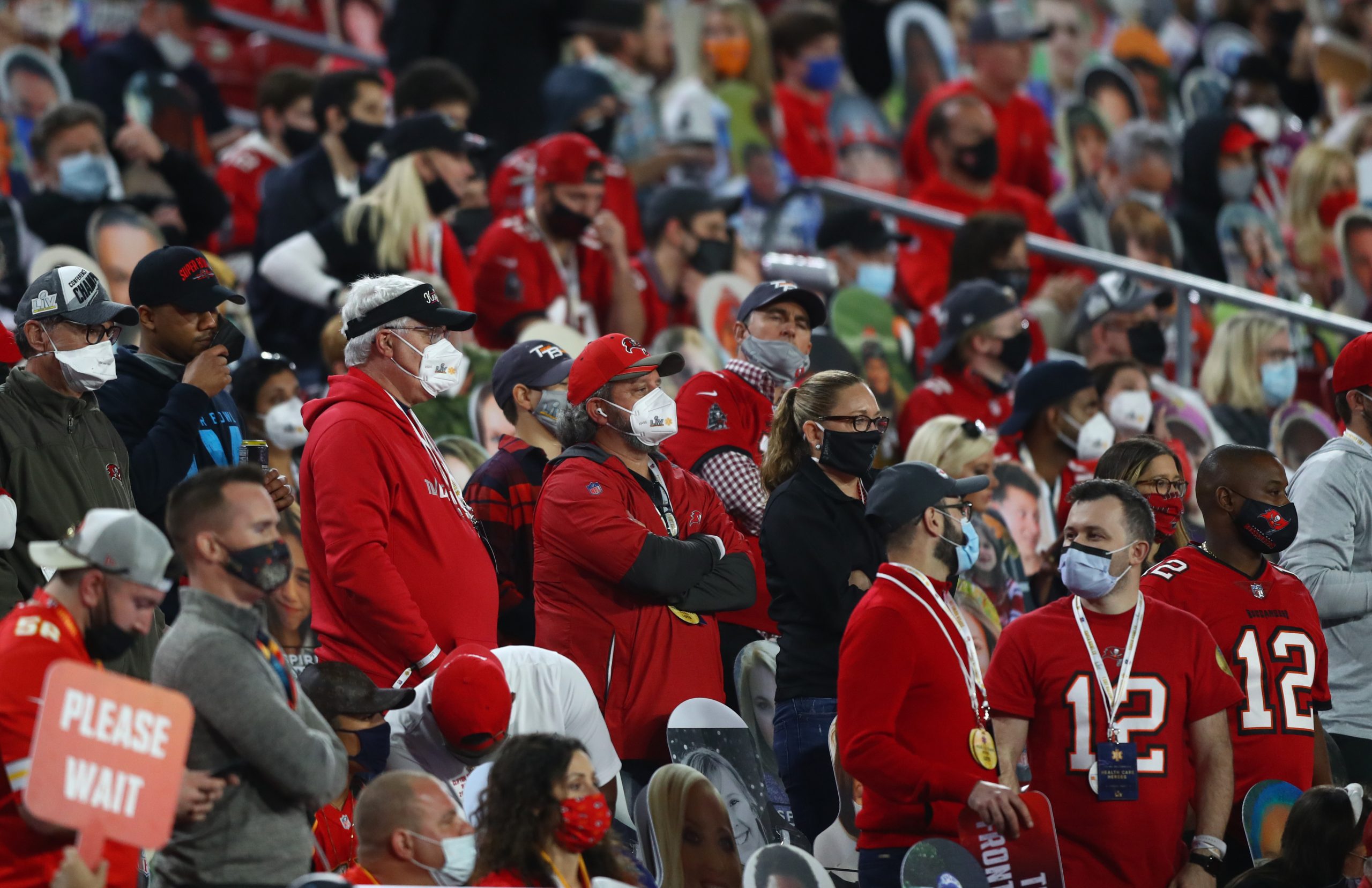 NFL Tampa Bay Buccaneers fans in the crowd wear face masks against the Kansas City Chiefs in Super Bowl LV at Raymond James Stadium