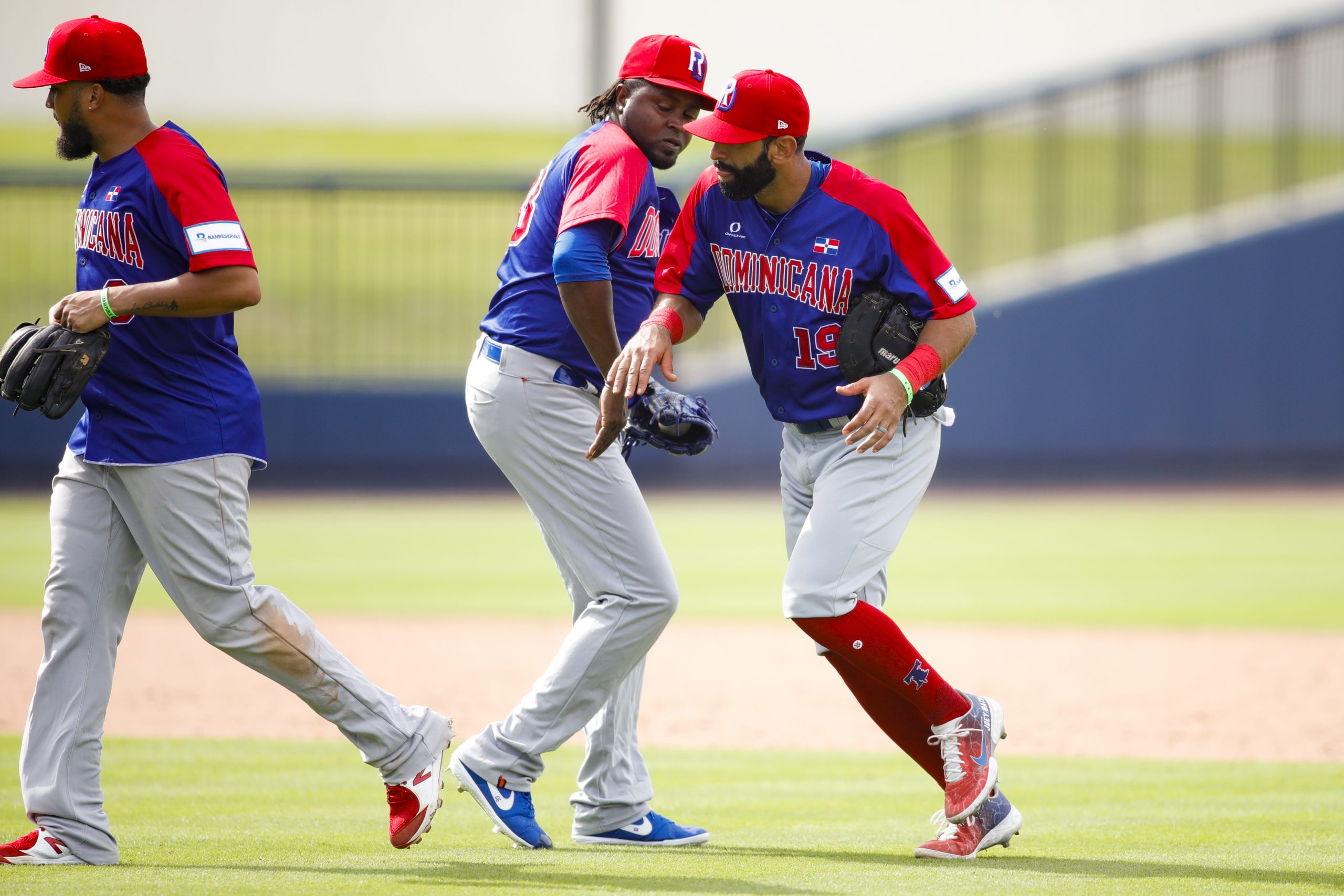 Dominican Republic first baseman Jose Bautista (19) celebrates with relief pitcher Jairo Asencio (33) after winning the game against Venezuela during the Super Round of the WBSC Baseball Americas Qualifier series at The Ballpark of the Palm Beaches