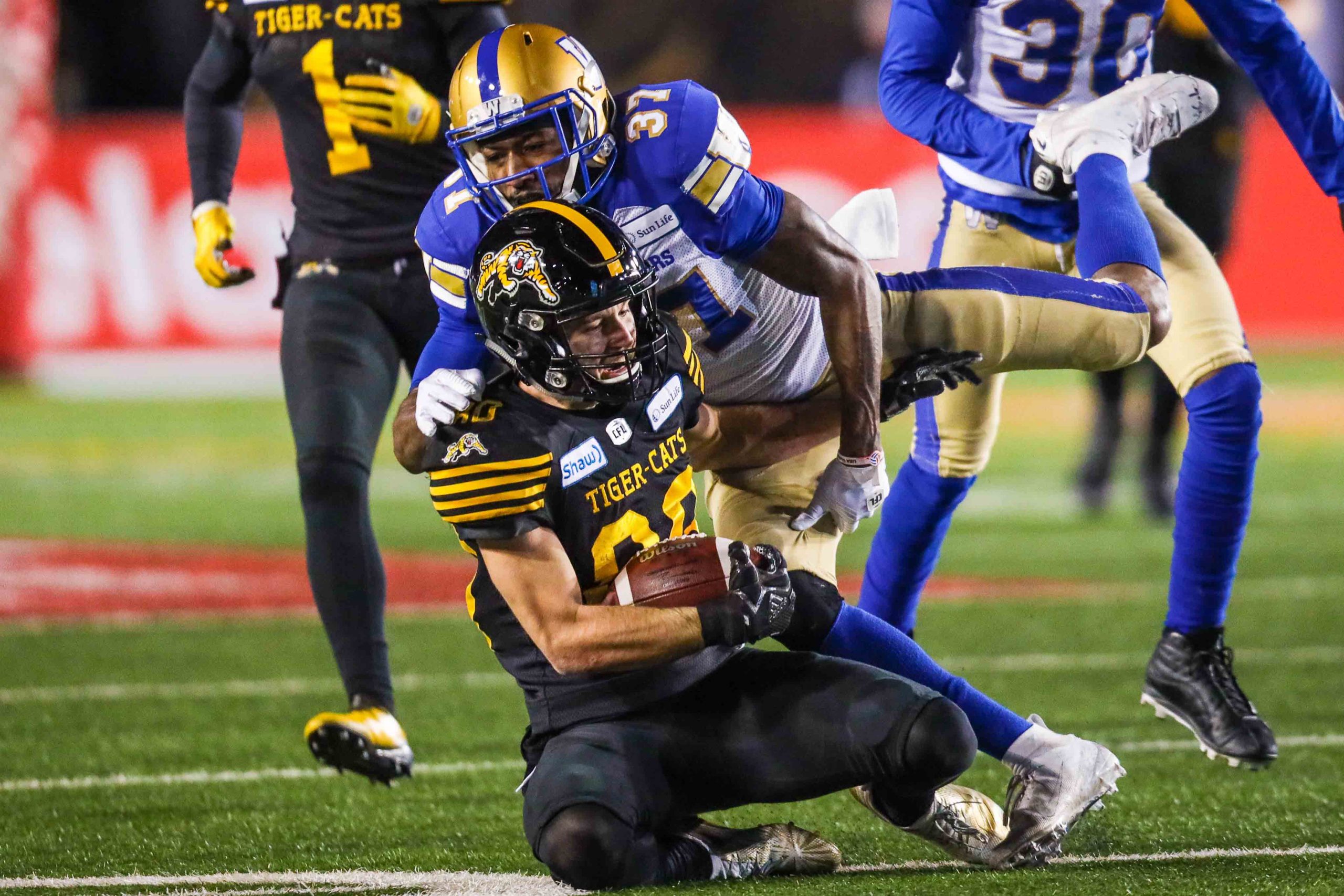 Hamilton Tiger-Cats wide receiver Jaelon Acklin (80) tackled by Winnipeg Blue Bombers defensive back Brandon Alexander (37) in the second half during the 107th Grey Cup championship football game.