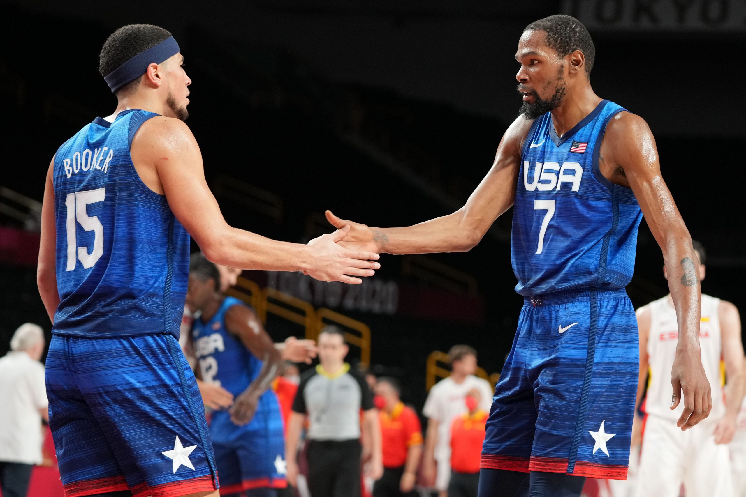 USA player Devin Booker (15) and USA player Kevin Durant (7) congratulate each other after USA beat Spain during the Tokyo 2020 Olympic Summer Games at Saitama Super Arena.