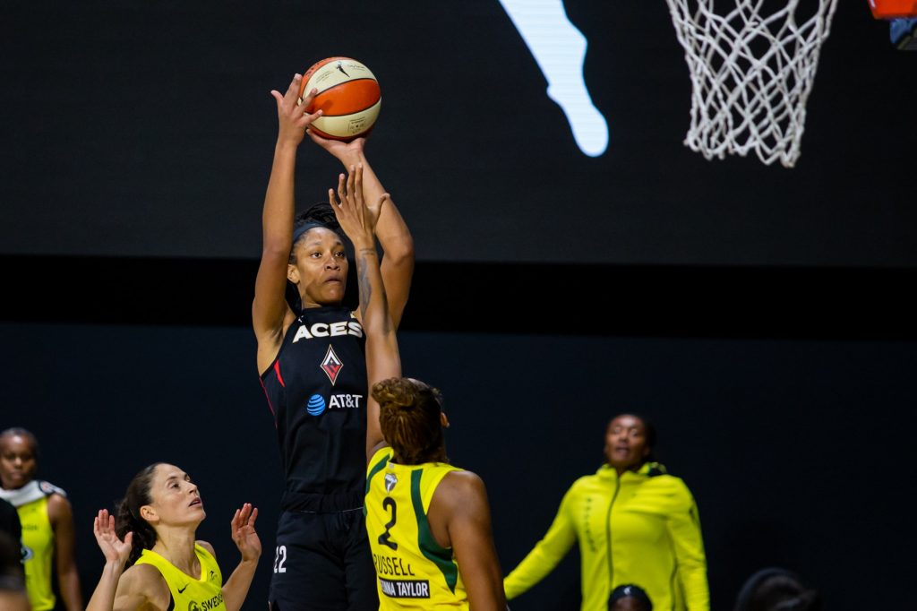 Aces' A'ja Wilson shoots over a defender.