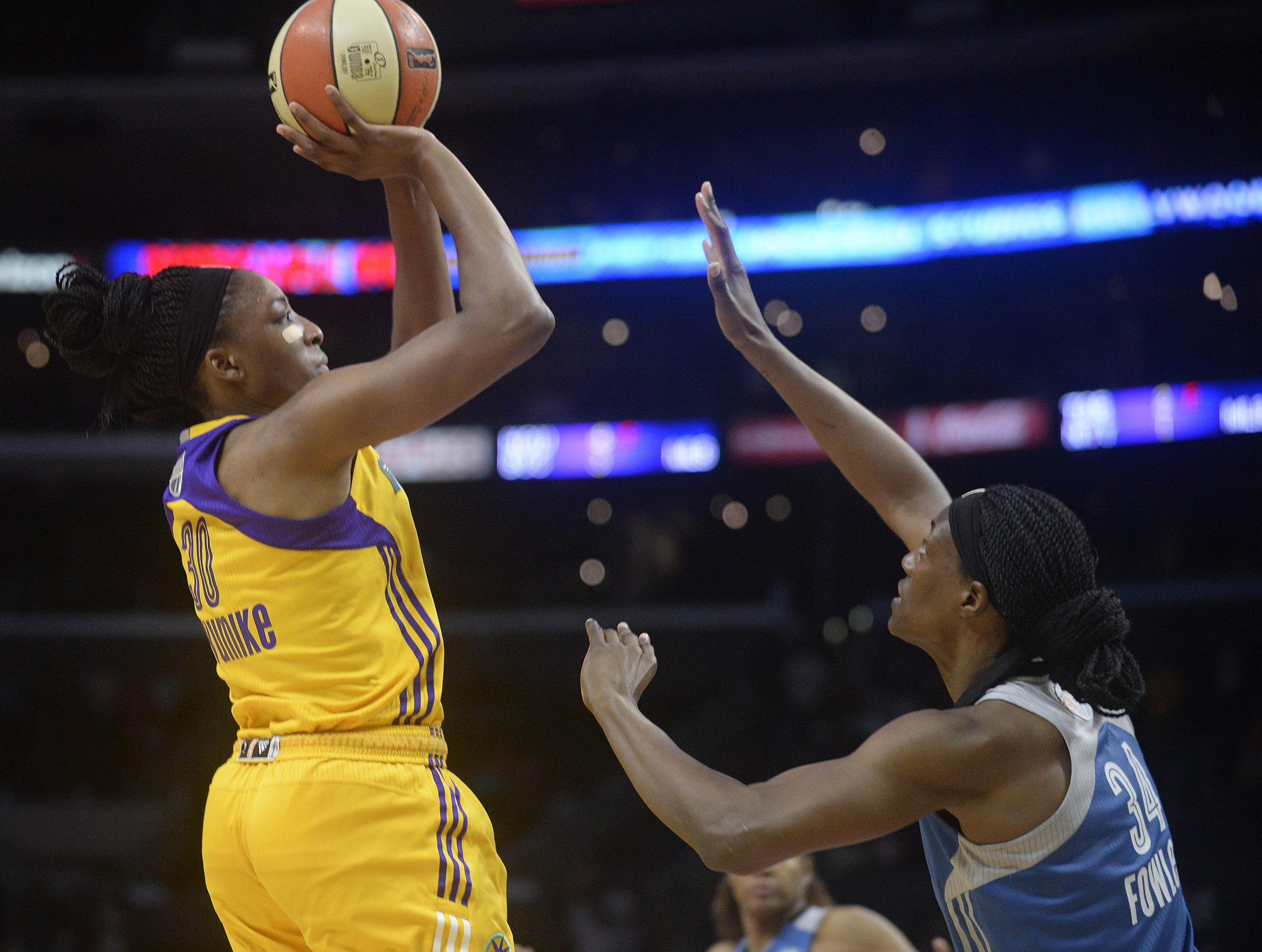 Los Angeles Sparks forward Nneka Ogwumike (30) shoots against Minnesota Lynx center Sylvia Fowles (34).