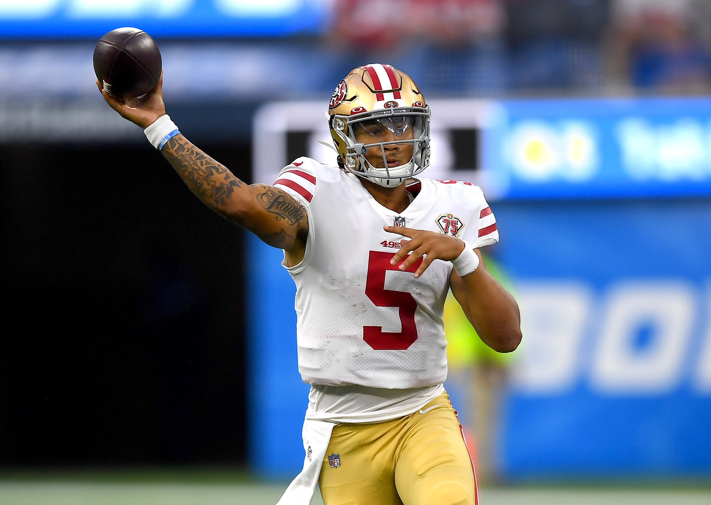 San Francisco 49ers quarterback Trey Lance (5) scrambles in the pocket before throwing a pass in the second half against the Los Angeles Chargers at SoFi Stadium