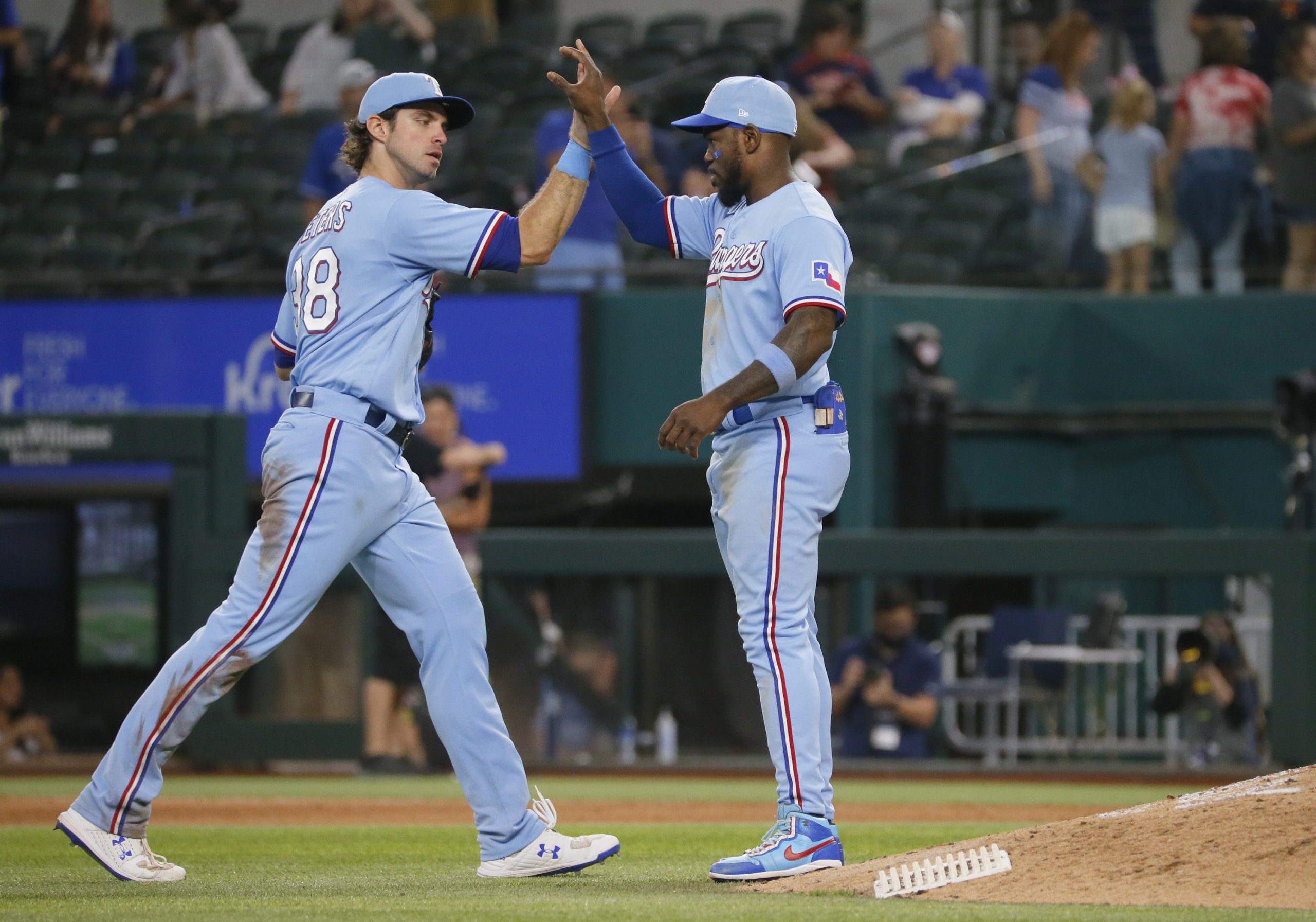 Texas Rangers center fielder DJ Peters (38) high fives right fielder Adolis Garcia (53) following the game against the Houston Astros at Globe Life Field