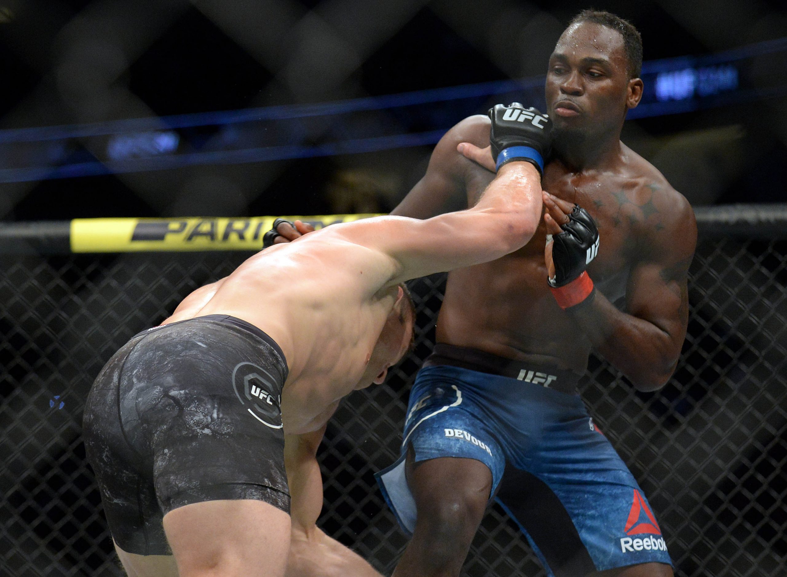 August 17, 2019; Anaheim, CA, USA; Ian Heinisch moves in with a hit as Derek Brunson defends during UFC 241 at Honda Center.