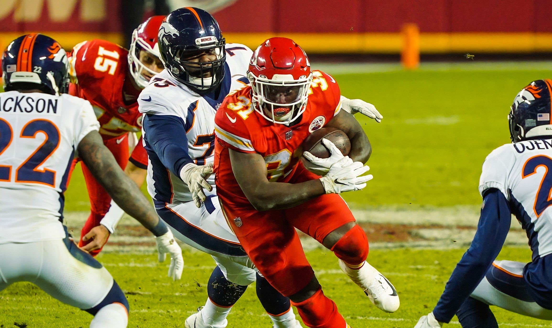 Kansas City Chiefs running back Darrel Williams (31) runs against Denver Broncos strong safety Kareem Jackson (22) and defensive tackle Sylvester Williams (73) and cornerback Michael Ojemudia.